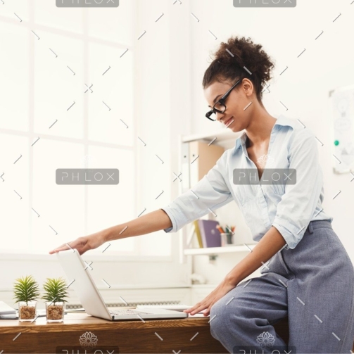 demo-attachment-184-business-woman-opening-laptop-at-office-PU4ZAGW