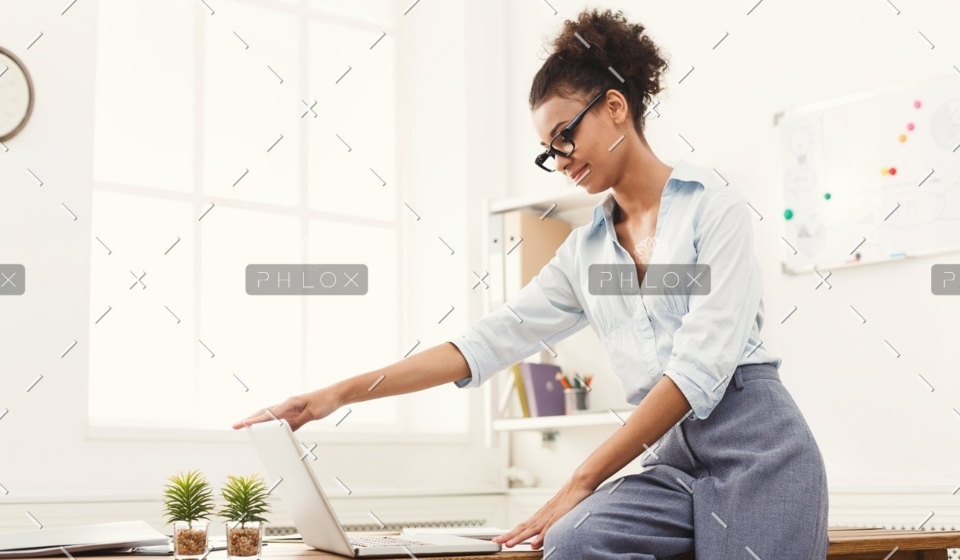 demo-attachment-184-business-woman-opening-laptop-at-office-PU4ZAGW